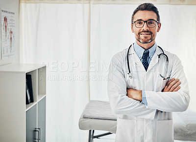 Buy stock photo Portrait of a confident doctor posing with his arms crossed in his consultation room