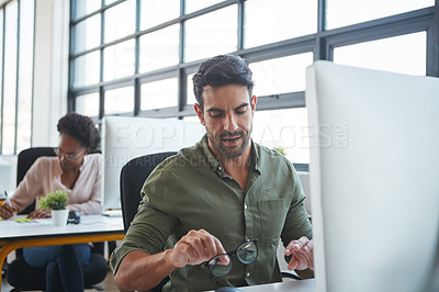 Buy stock photo Working, business man and computer typing of a marketing employee in a office. Thinking, businessman and coworking workplace of a worker doing website ux strategy research cleaning glasses to work