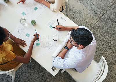 Buy stock photo High angle shot of a team of businesspeople having a meeting around a table in their office