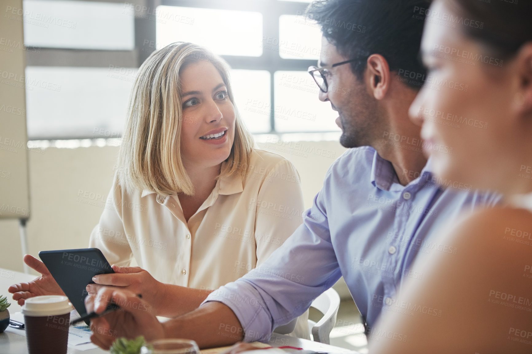 Buy stock photo Shot of a team of business colleagues discussing a project around a table in their office