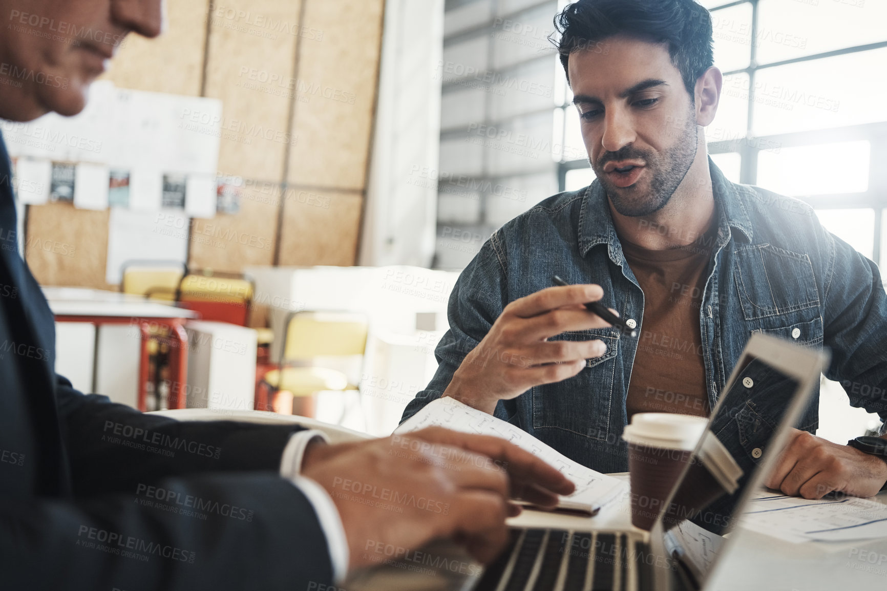 Buy stock photo Shot of a mature manager having a meeting with one of his colleagues at a table in the office