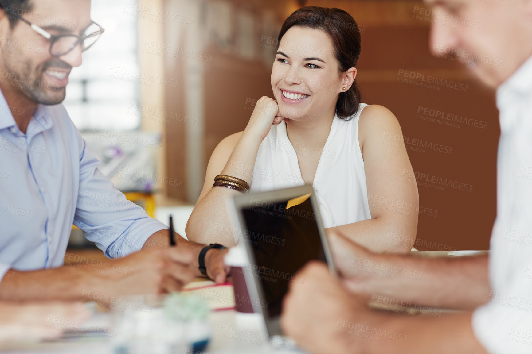 Buy stock photo Shot of a team of happy business colleagues discussing a project around a table in their office