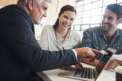 Buy stock photo Shot of a young married couple consulting with their financial advisor in his office