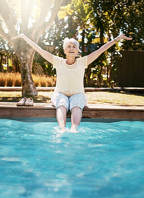 Buy stock photo Senior woman, smile and feet in swimming pool in relax for summer vacation, swim or holiday joy in the outdoors. Happy elderly female with arms stretched out in happiness for relaxation by water pool