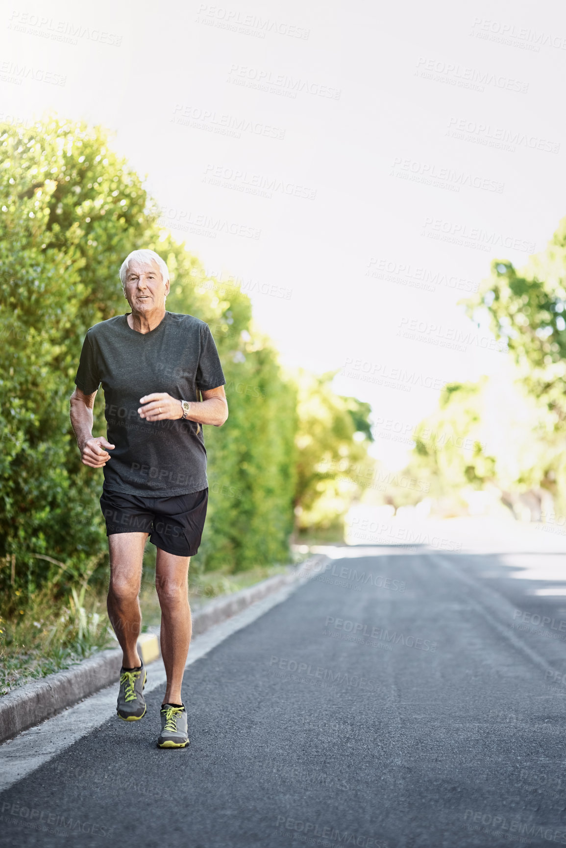 Buy stock photo Road, running and senior man in portrait for fitness, exercise and training outdoors with endurance for pace. Elderly athlete, runner and action with movement, cardio and marathon by mockup in nature