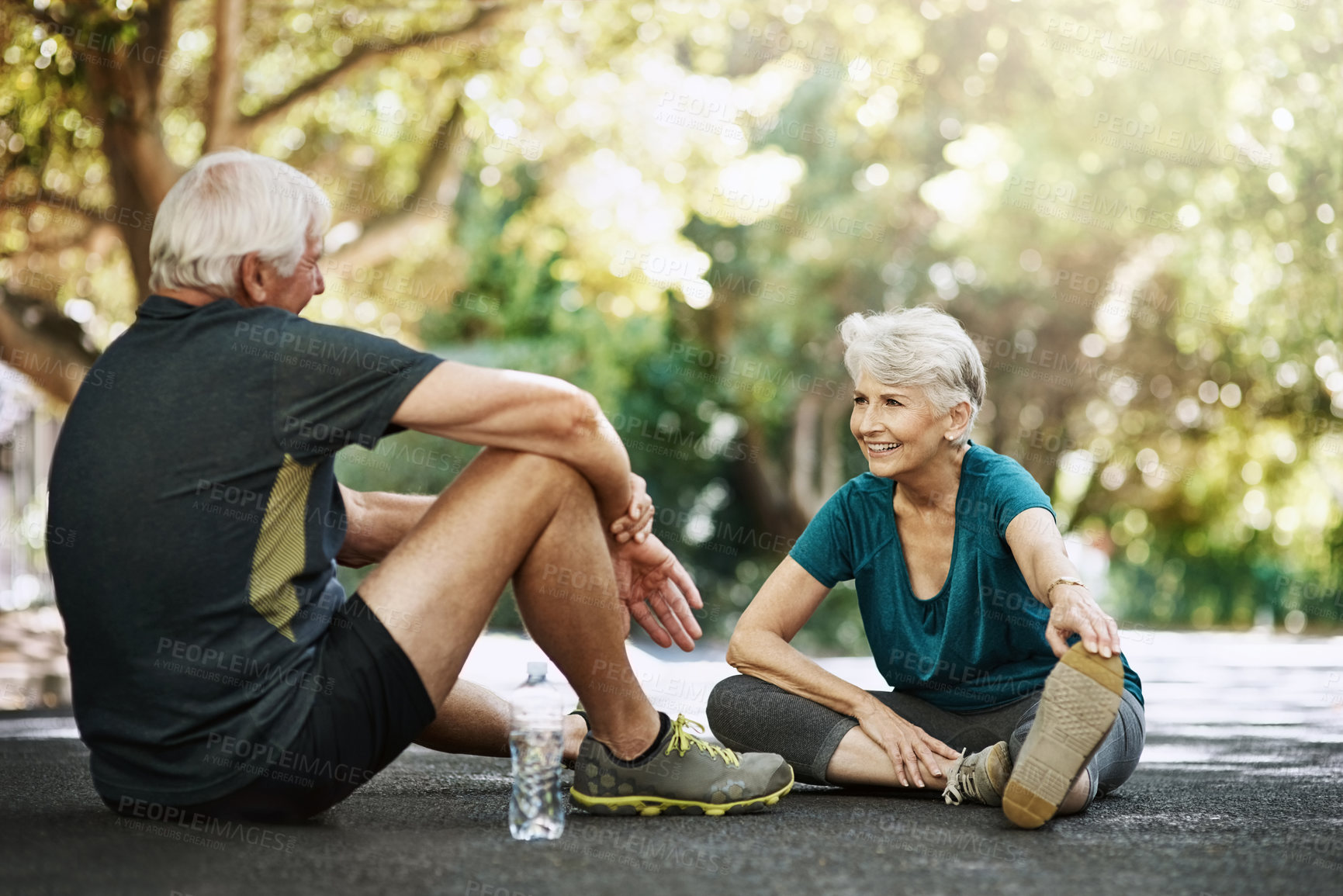 Buy stock photo Senior man, woman and sitting in street for workout, discussion for retirement with smile. Couple, exercise and together with pause for happiness on road, stretching with chat in neighborhood