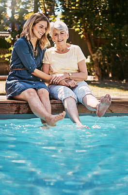 Buy stock photo Shot of a happy senior woman spending quality time with her daughter at the pool
