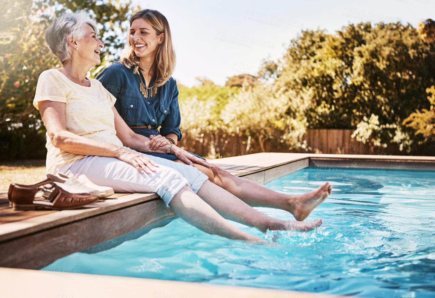 Buy stock photo Women relax together by swimming pool, love and care, quality time during summer vacation. Elderly mother, daughter and vacation, content outdoor with pool and wellness lifestyle with happy family