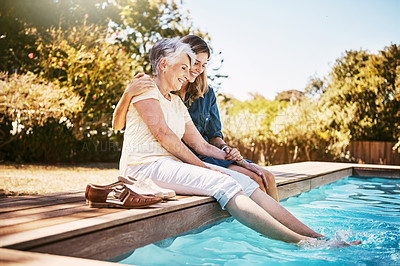 Buy stock photo Shot of a happy senior woman spending quality time with her daughter at the pool