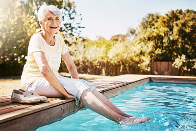 Buy stock photo Pool, portrait and senior woman by the water while on a vacation, adventure or outdoor trip in summer. Happy, smile and elderly lady in retirement with her feet in the swimming pool at holiday resort