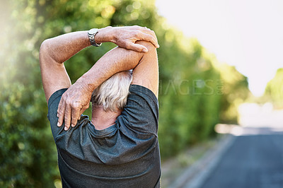 Buy stock photo Rear view shot of a senior man warming up before a run outside