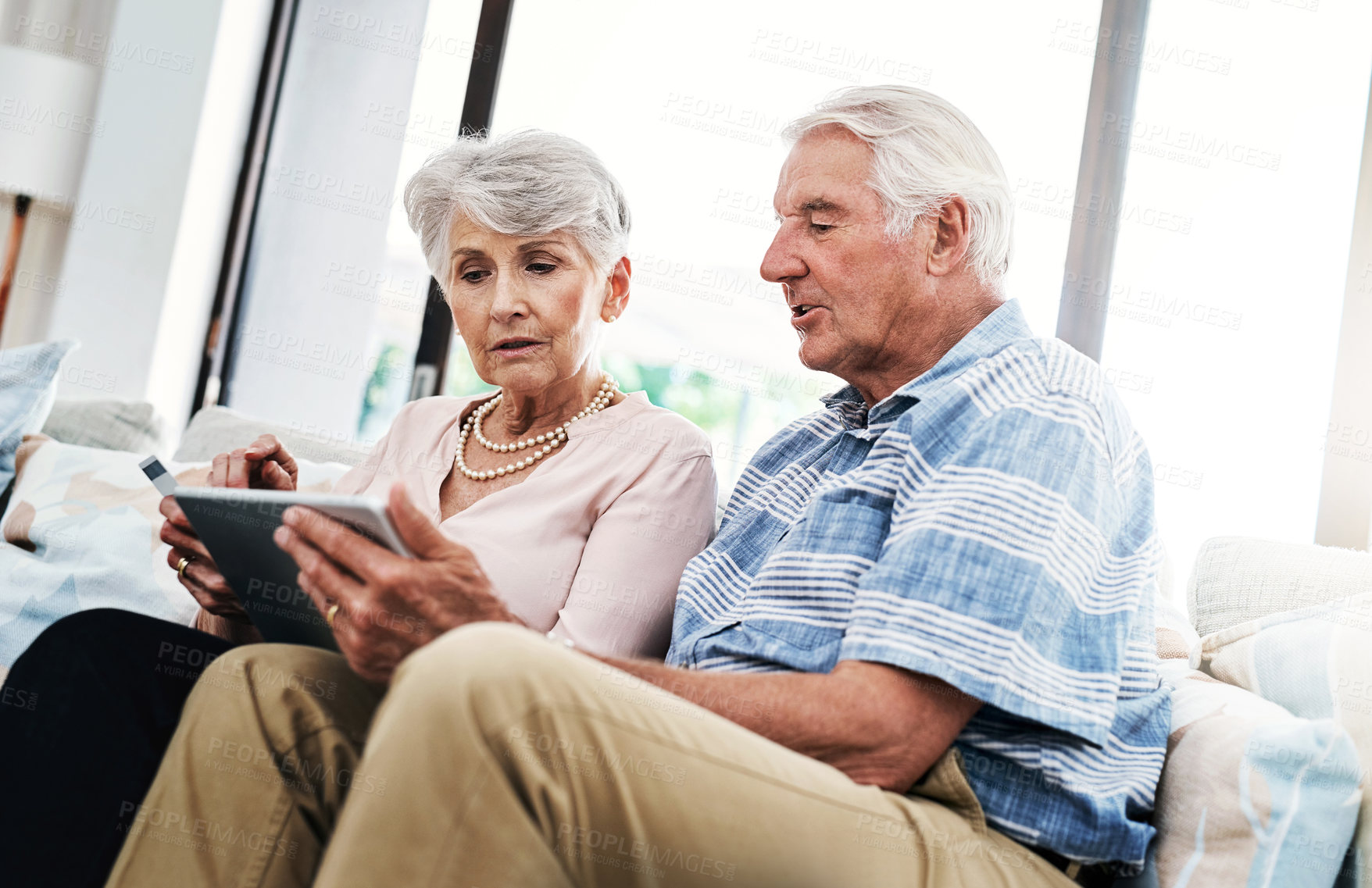 Buy stock photo Senior couple, house and tablet with credit card on sofa for online shopping, payment and retirement plan. People, happy and couch at home for internet banking, budget and investment or finance