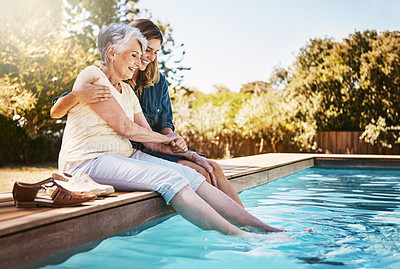 Buy stock photo Mother, daughter or happiness by swimming pool for bonding, hug or relax with lens flare in garden. Senior mom, woman or outdoor with smile for wellness, family with embrace or love and feet in water