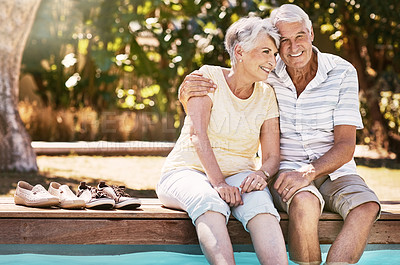 Buy stock photo Senior couple, hug and swimming pool for summer vacation, love or relax spending quality bonding time together. Happy elderly man holding woman relaxing with feet in water by the poolside outside