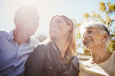 Buy stock photo Shot of a happy young woman spending quality time with her elderly parents outdoors
