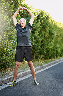 Buy stock photo Portrait of a senior man warming up before a run outside