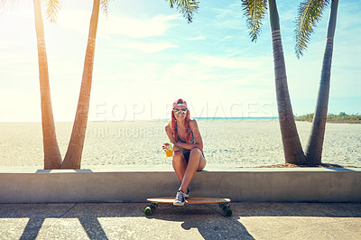 Buy stock photo Shot of a young woman hanging out on the boardwalk with her skateboard