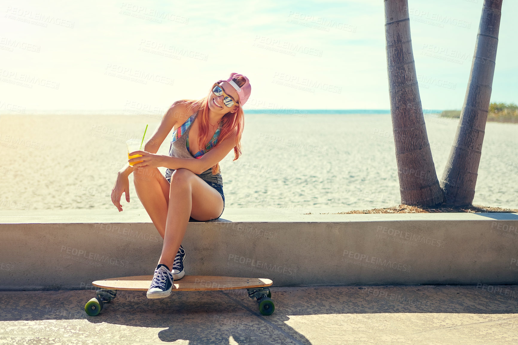 Buy stock photo Woman, beach and relax with skateboard for holiday, smile and sunglasses by promenade. Summer girl, travel and tourism by ocean with skater style, outdoor hobby and break on vacation or trip in Miami