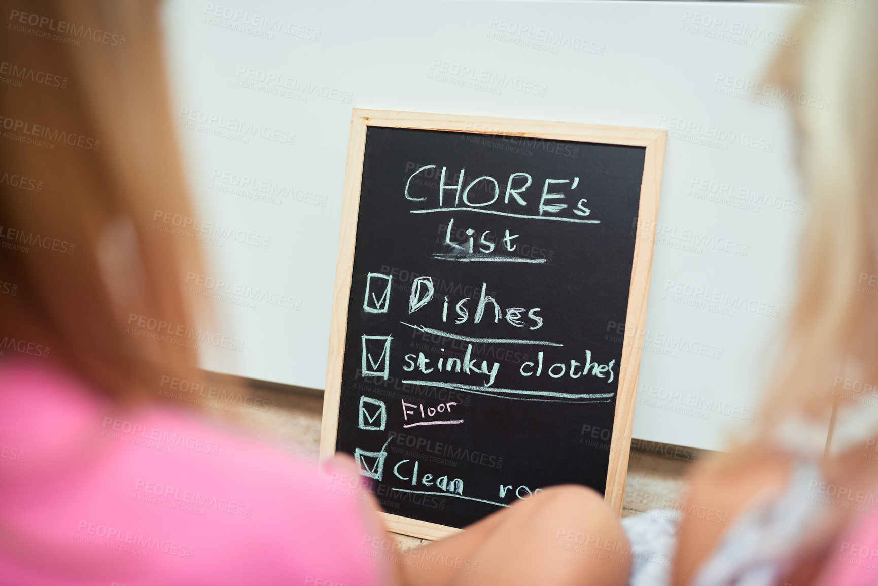 Buy stock photo Children, chalkboard and list of chores in home, back and reading for help, teamwork or development in morning. Kids, blackboard or notes on floor, schedule or planning for cleaning in family house