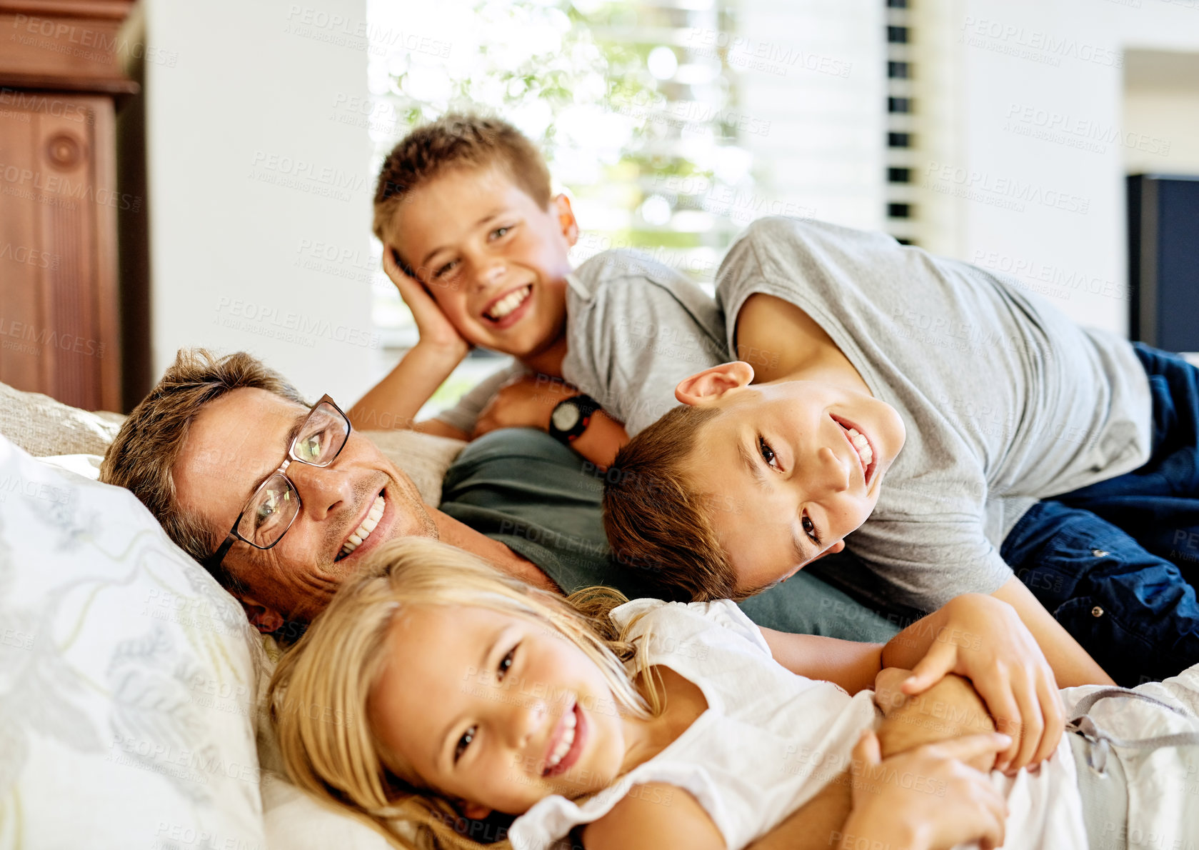 Buy stock photo Portrait of a father spending quality time with his three little kids at home