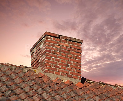 Buy stock photo Closeup of a chimney on an old red brick house with copy space sky. Architectural details of an antique steel roof on a residential building. Stone exterior design of a home furnace without smoke