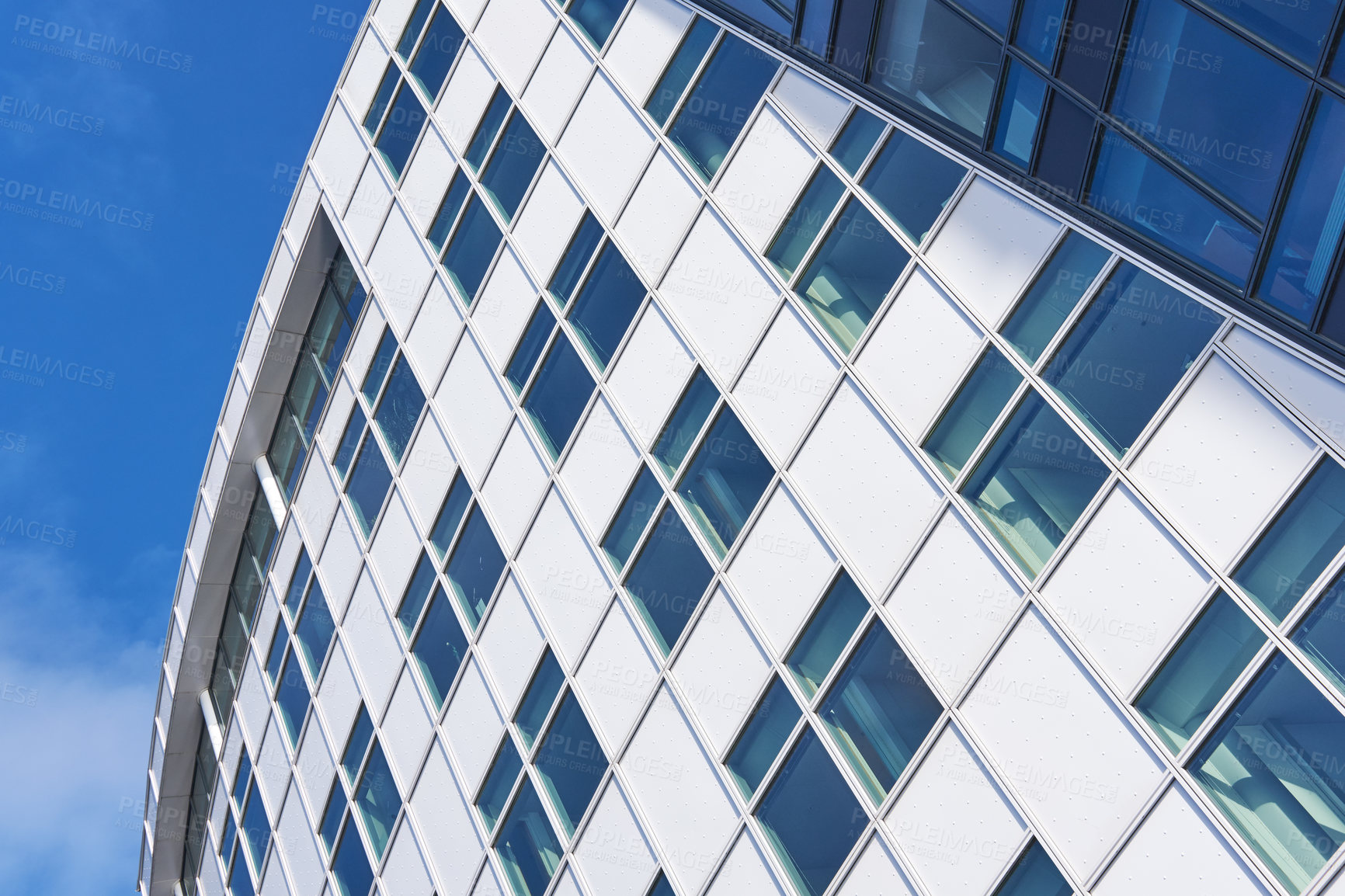 Buy stock photo Building, architecture and glass windows with blue sky below for industrial development, infrastructure or construction. Low angle, structure or architecture with exterior detail in an urban suburb