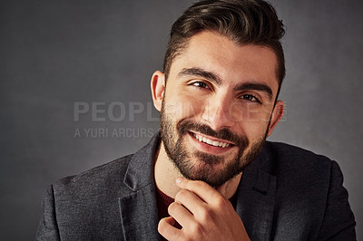 Buy stock photo Studio portrait of a handsome young man posing against a dark background