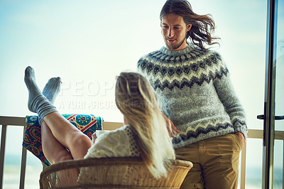 Buy stock photo Shot of a young couple relaxing on their balcony