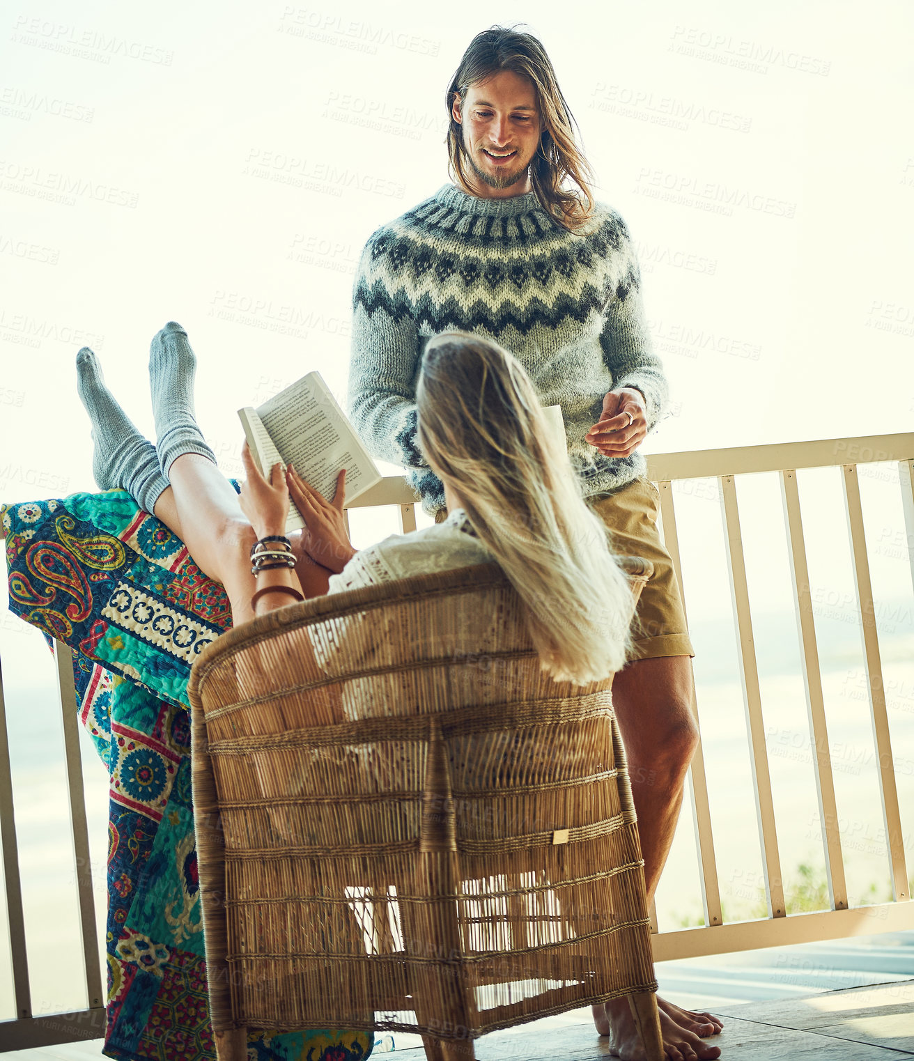 Buy stock photo Shot of a young couple relaxing on their balcony