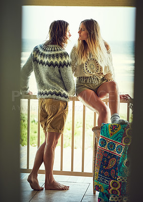 Buy stock photo Shot of a young couple relaxing on their balcony