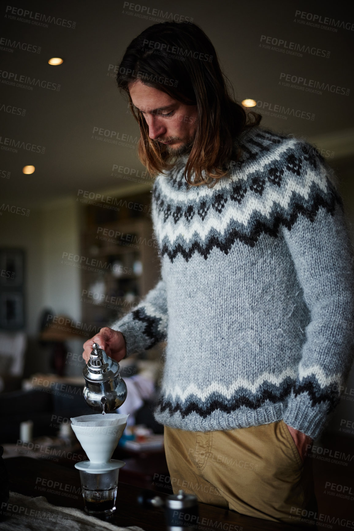 Buy stock photo Shot of a young man preparing coffee in his kitchen