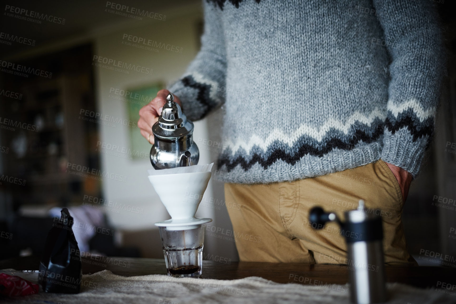 Buy stock photo Cropped shot of a man preparing coffee in his kitchen