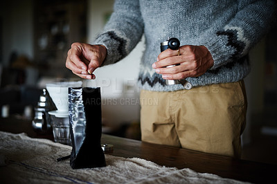 Buy stock photo Cropped shot of a man preparing coffee in his kitchen