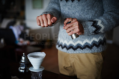 Buy stock photo Cropped shot of a man preparing coffee in his kitchen