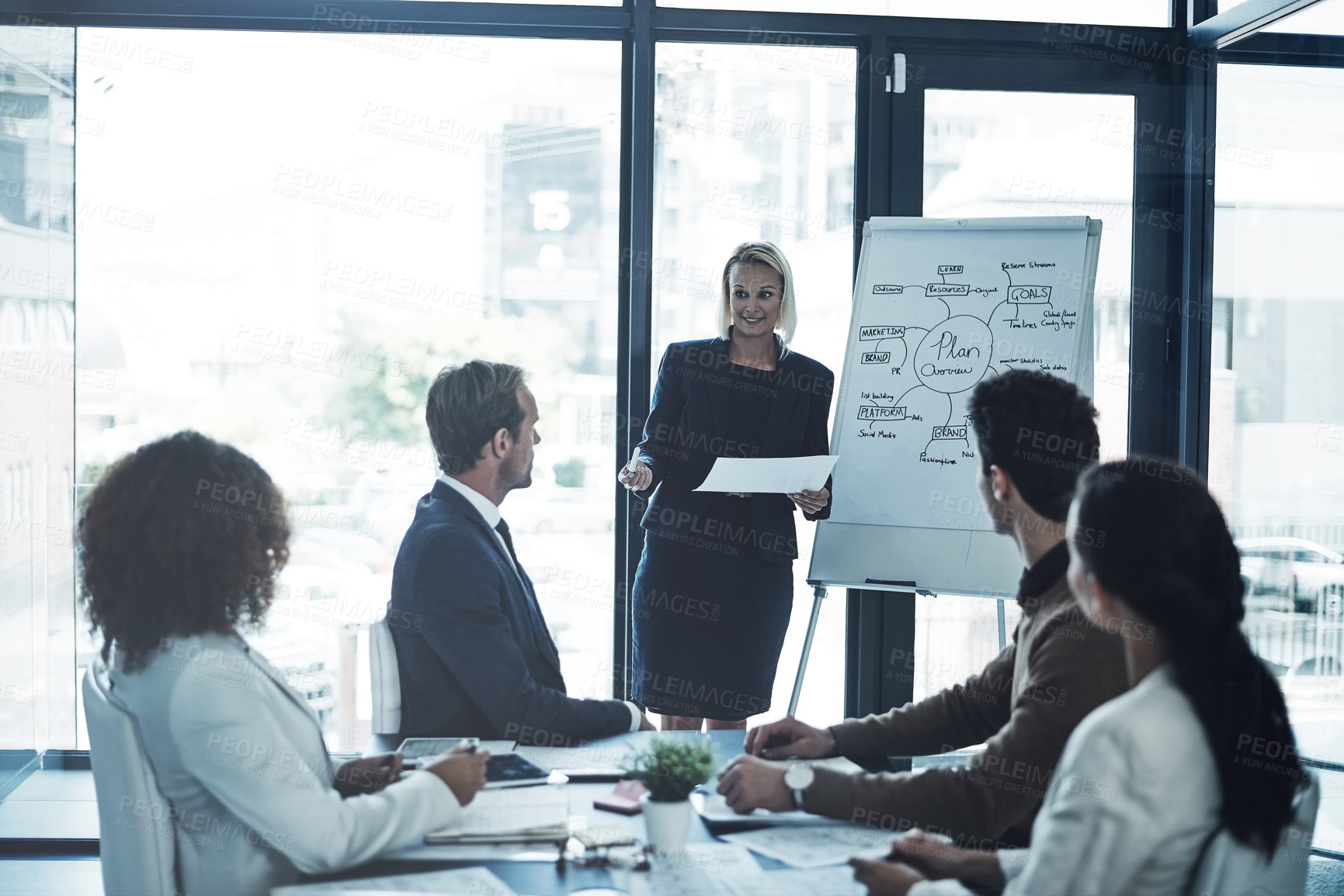 Buy stock photo Shot of a corporate businesswoman giving a presentation to her colleagues in the boardroom