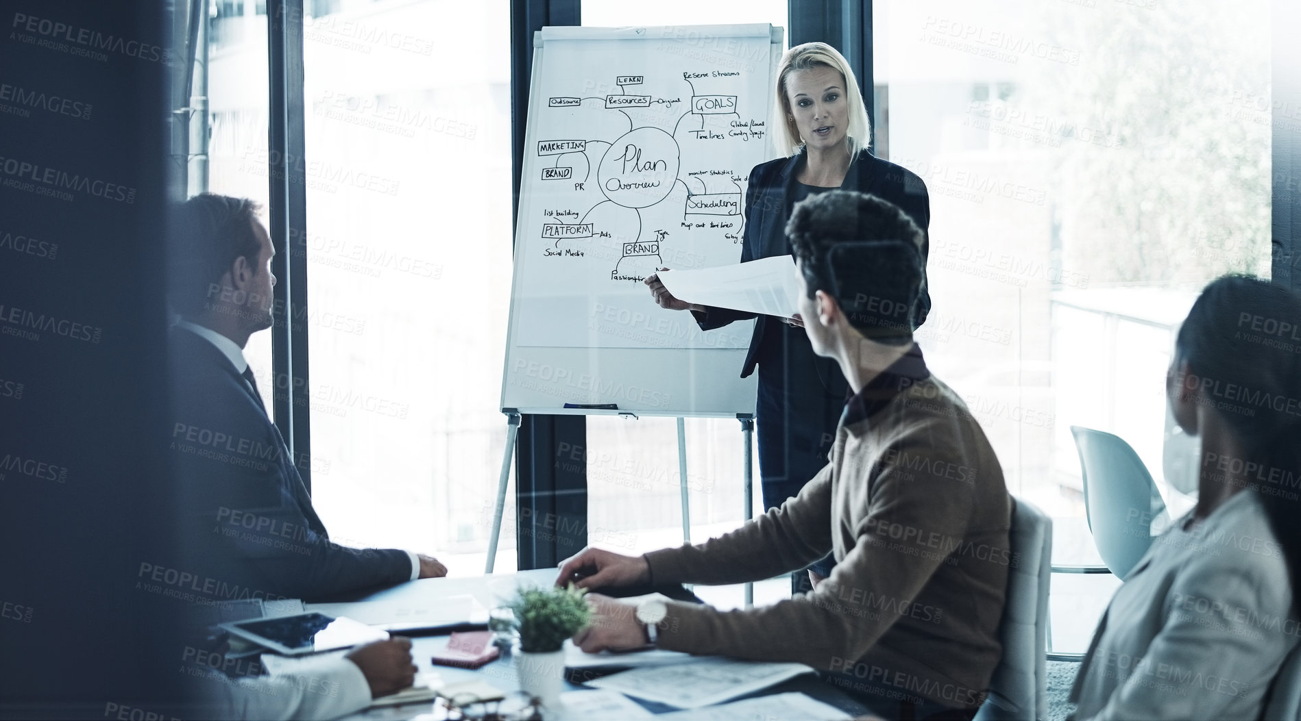 Buy stock photo Shot of a corporate businesswoman giving a presentation to her colleagues in the boardroom