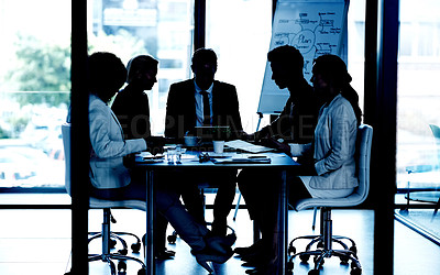 Buy stock photo Shot of a group of corporate colleague having a meeting around a table in the boardroom