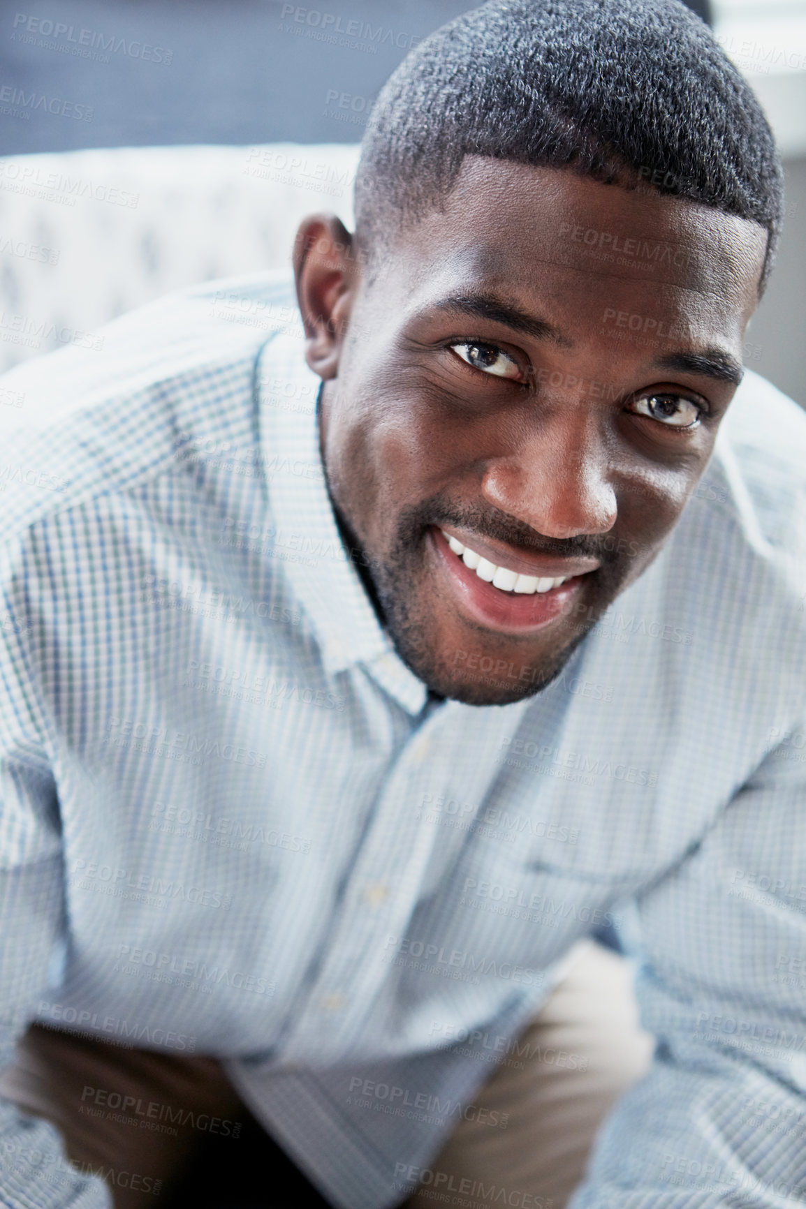 Buy stock photo Portrait of a happy young man relaxing on the sofa at home