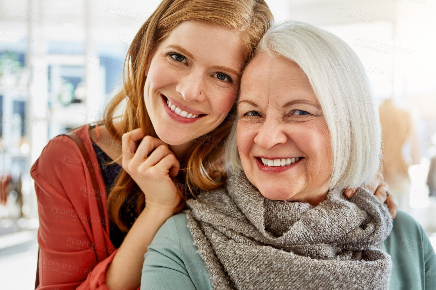 Buy stock photo Shot of a happy young woman standing behind her senior mother