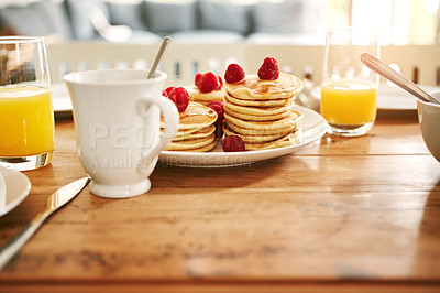 Buy stock photo Closeup shot of pancakes, juice and a mug on a breakfast table