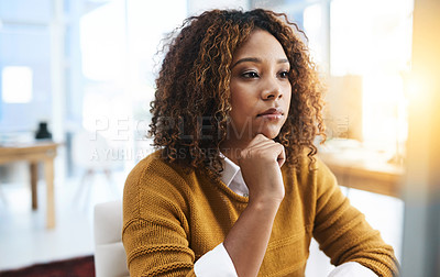 Buy stock photo Shot of a focused young businesswoman siting and working in the office at work