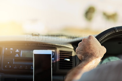 Buy stock photo Cropped shot of a unrecognizable man driving in a vehicle with his cellphone   attached to the dashboard