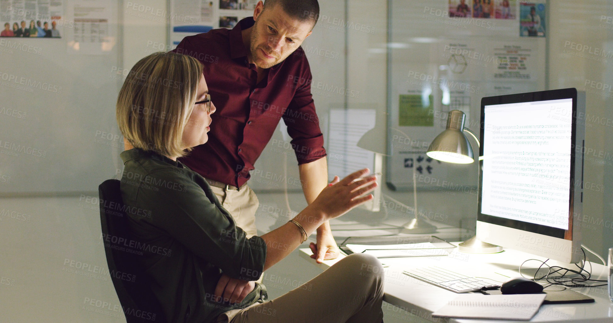 Buy stock photo Cropped shot of two businesspeople working together on a computer in their office