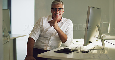 Buy stock photo Cropped portrait of a mature businessman sitting at his desk in the office