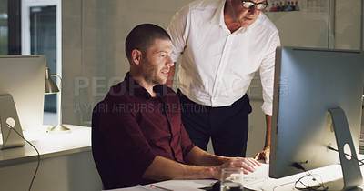 Buy stock photo Cropped shot of two businessmen working together on a computer in their office