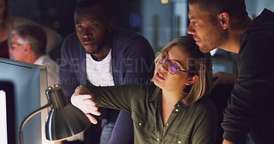 Buy stock photo Cropped shot of a group of businesspeople working together on a computer in their office