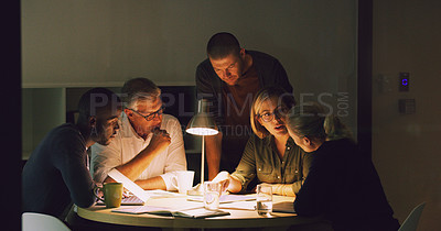 Buy stock photo Cropped shot of a group of businesspeople working together around a table in their office