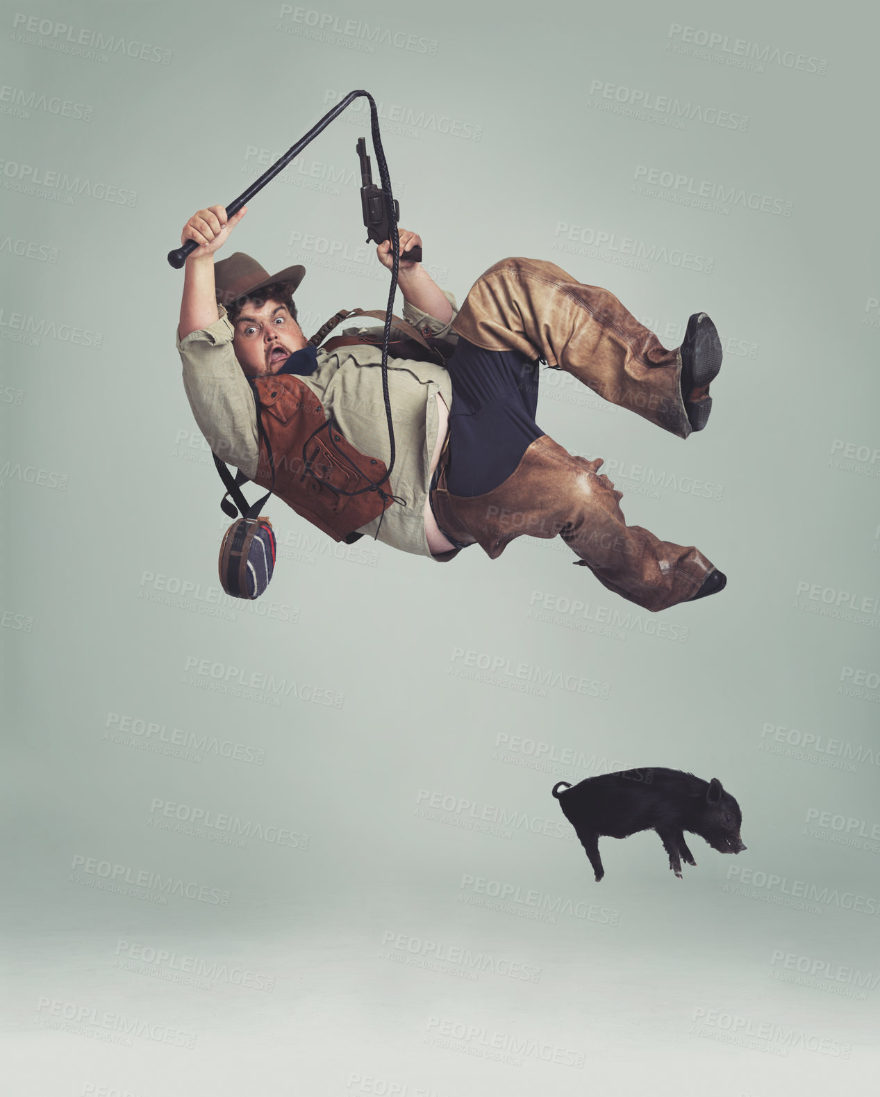 Buy stock photo Cowboy, accident and man catching pig for texas culture in studio on gray background with space. Western, animal or noose and clumsy young person in costume with fail, mistake or oops for falling
