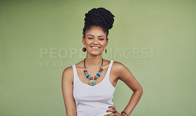 Buy stock photo Portrait of an attractive and trendy young woman posing against a green background