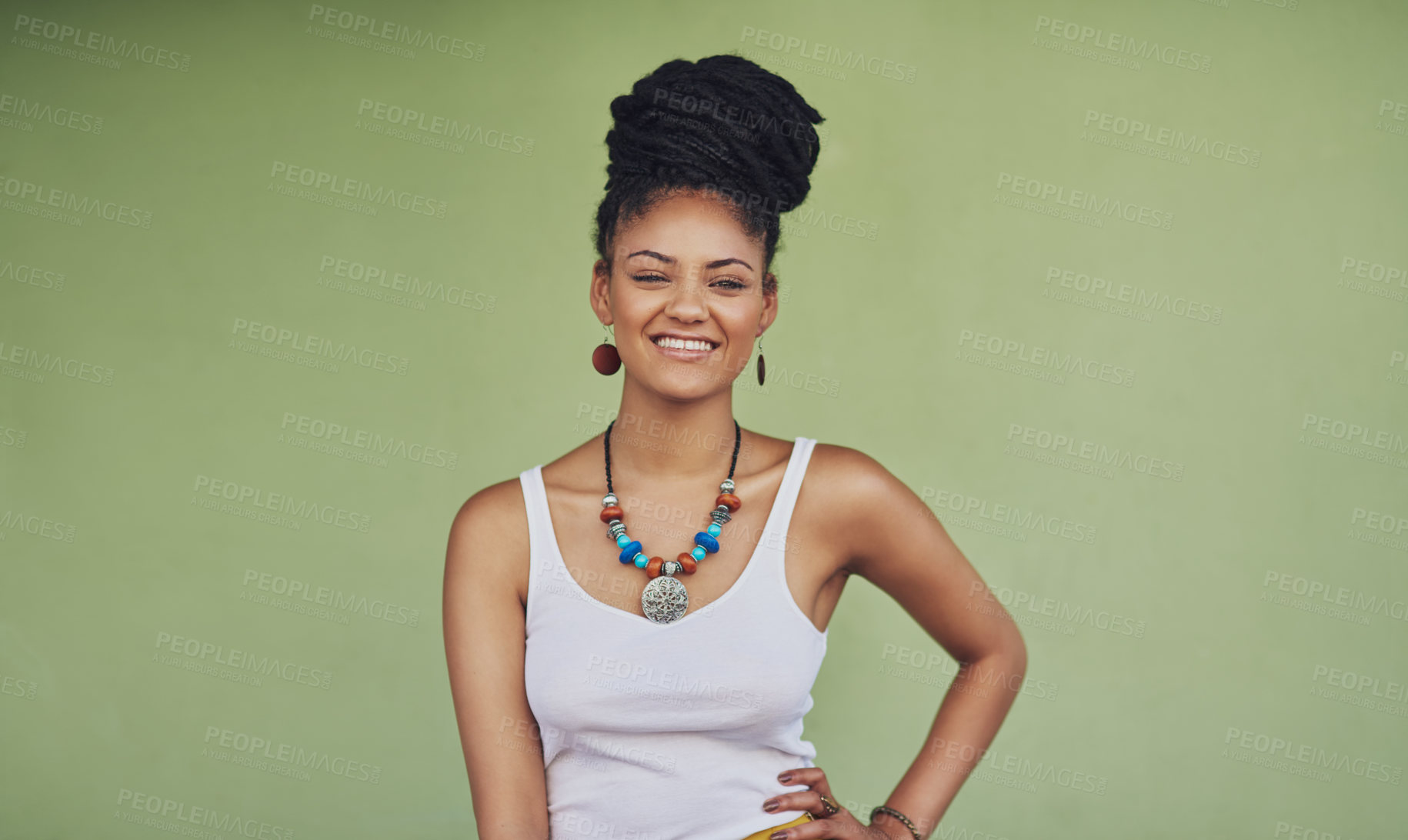 Buy stock photo Portrait of an attractive and trendy young woman posing against a green background